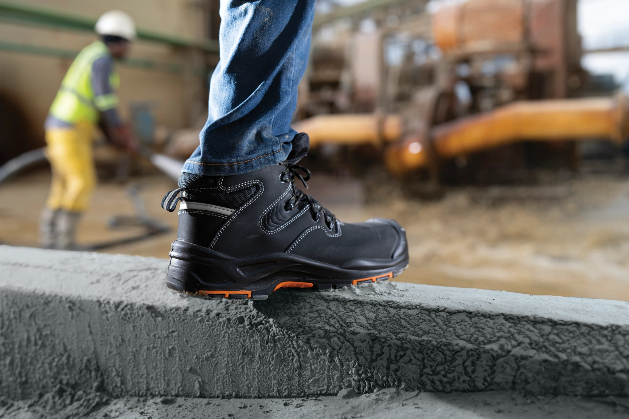 Quest safety boot worn on a concrete block at a working construction site